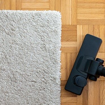 Vacuum cleaner extension on a laminated wooden floor | Rockwall Floor and Paint
